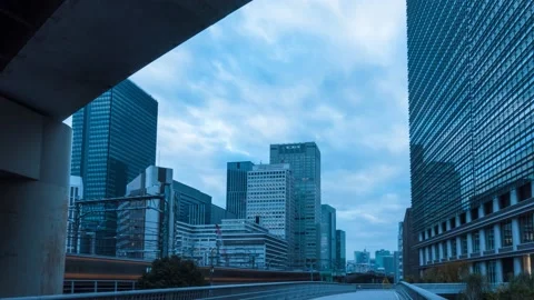 Time Lapse of clouds over office buildings in Tokyo, Japan Stock Footage 145504373