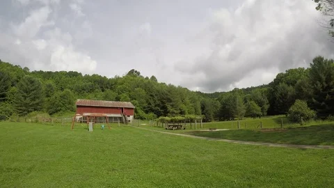 Time lapse with clouds over old country barn Stock Footage