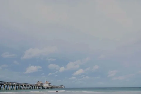 Time Lapse of Clouds Over Pier in Ocean Видео 76929166
