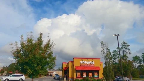 Time-lapse of clouds over Popeyes chicken Stock Footage 142972230