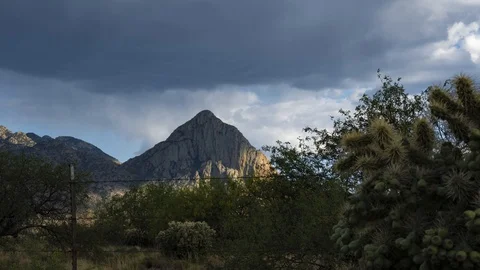 Time lapse of clouds over a prominent desert mountain peak Stock Footage 130116942