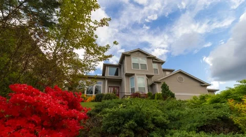 Time lapse of clouds over residential home with blooming azaleas springtime 4k Stock Footage 62494438