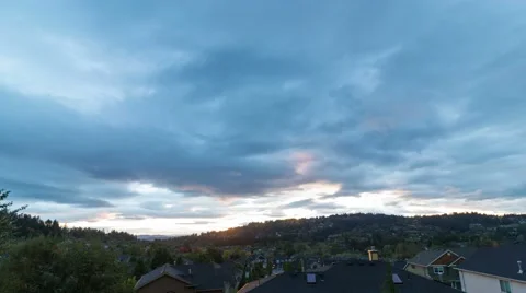 Time lapse of clouds over residential homes in Happy Valley OR at sunset 4k uhd Video stock 68410443