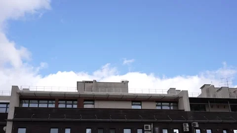 Time lapse of clouds over a residential building Stock Footage 272592636