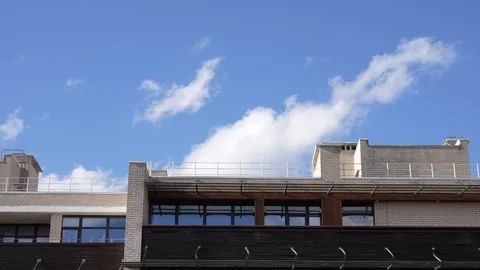 Time lapse of clouds over a residential building Stock Footage 304261984