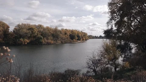 Time lapse with clouds over river in autumn Stock Footage 257461377