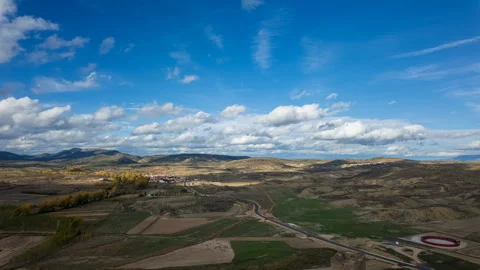 Time-lapse clouds over rolling Spanish farmland from castle tower Vídeos de archivo 327708858