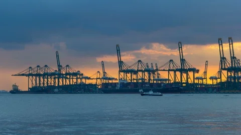 Time lapse of clouds over shipping facilities along Singapore Straits sunset 4k Stock Footage 86937667