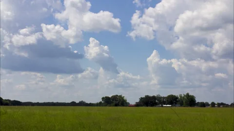 Time lapse of clouds over sunny pasture Stock Footage 27730781