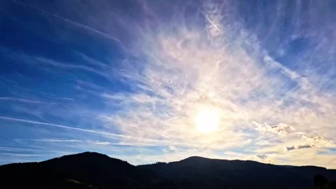 Time lapse of clouds over sunny hills with planes Stock Footage 315783837