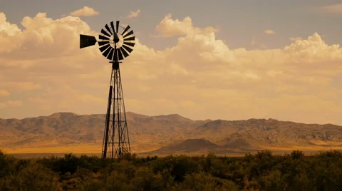 Time Lapse Clouds Over Wild West Windmill at Sunset Stock Footage