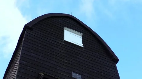 Time Lapse: Clouds pass over a wooden windmill tower Stock Footage 45905120