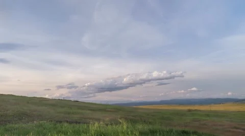 Time Lapse of Clouds Passing Over Rolling Green Hills Stock Footage 55809906