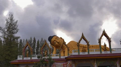 Time lapse of clouds passing over Buddha statue with people passing by Stock Footage 56468665