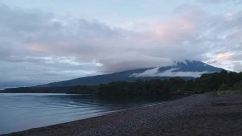 Time lapse Of Clouds Passing Over A Volcano Peak In Front Of A Patagonia Lake Stock Footage 70379996