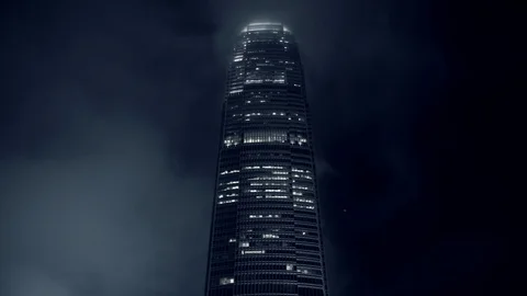 Time Lapse of Clouds passing over Corporate Skyscraper at Night in Hong Kong Stock Footage 87205810