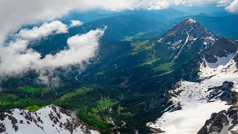 Time lapse of clouds passing over the mountains with green grass Stock Footage 91183452