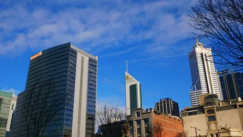 Time lapse of clouds passing over skyscrapers in the city Stock Footage 92923893