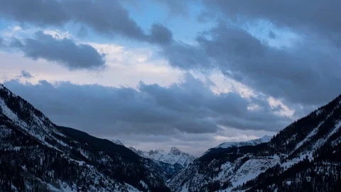 Time-lapse of clouds passing over the beautiful snow-covered mountains Stock Footage 116786140