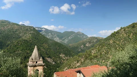 Time lapse of clouds passing over mountains, seen from village in Italy. Stock Footage 139862913