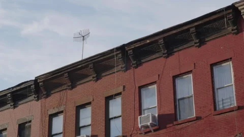 Time lapse of clouds passing over a row of Brownstones Stock Footage 278184012