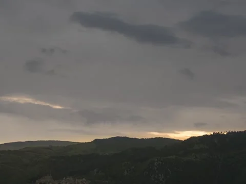 Time lapse of clouds passing over Mountains during a vary cloudy morning Stock Footage 281795343