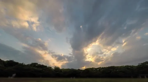 Time lapse of clouds passing overhead at sunset in Yoyogi park in Tokyo Stock Footage 49605315