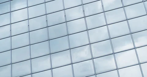 Time lapse clouds passing shiny office windows loop 4K Stock Footage 64057863