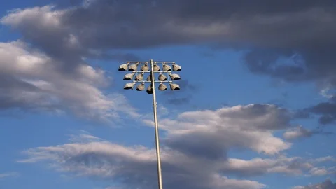 Time lapse of clouds passing by stadium lights Stock Footage 103867252