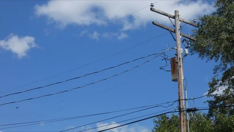 Time lapse of clouds passing through the sky behind telephone pole Видео 88677402