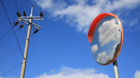 Time lapse of clouds reflected in a road convex mirror against telephone pole Stock Footage 58003498