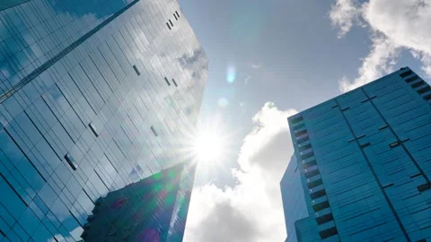 Time lapse of clouds reflecting into the glass of a large office building Stock Footage 246643802