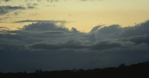 Time lapse: Clouds rolling and shifting at dusk over mountain tree line Stock Footage 85984766