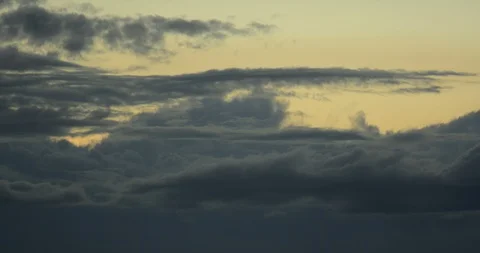 Time lapse: Clouds rolling and shifting at dusk over mountain tree line zoom v1 Stock Footage 85990392