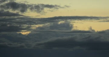 Time lapse: Clouds rolling and shifting at dusk over mountain tree line zoom v2 Stock Footage 85990897