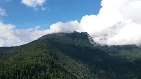 Time-lapse of clouds rolling off a hill Stock Footage