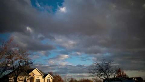 Time-lapse of clouds rolling by a house 스톡 동영상 143167924