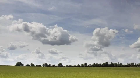 Time lapse of clouds rolling over a hay meadow Stock Footage 41405828