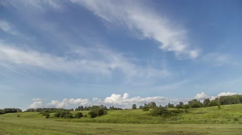 Time lapse of clouds rolling over a hay meadow in countryside on a summers day. Stock Footage 52378429