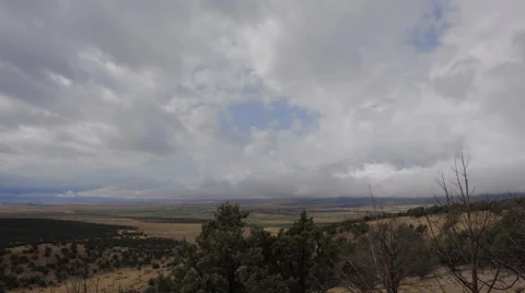 Time lapse-clouds rolling over rural mountain valley Stock Footage 67878250