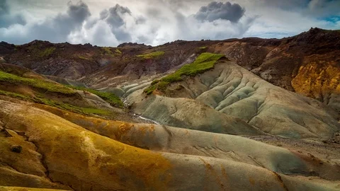 Time lapse of clouds rolling over Geothermal clay canyon and mountains Stock Footage 73011344
