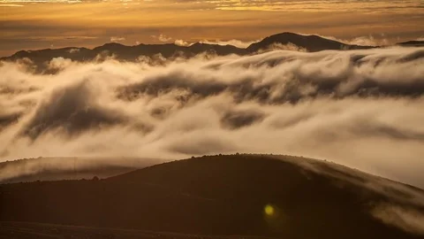 Time Lapse of clouds rolling over mountain landscape Stock Footage 73843846