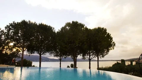 Time lapse of clouds rolling over sunset infinite pool Stock Footage 82869821