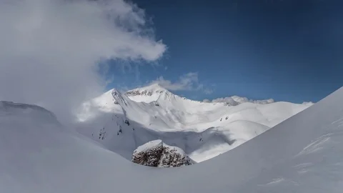 Time lapse of clouds rolling  over snowy  peaks Stock-Footage 83691497