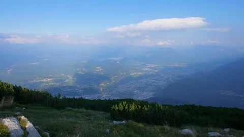 Time-lapse of clouds rolling over the mountain ranges and green grass on slope Stock Footage 109293789