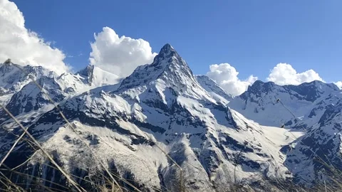 Time lapse of clouds rolling over snowy peaks. Belalakaya mountain, Dombay. Stock Footage 155252202