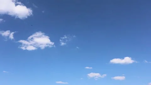 Time Lapse Clouds Rolling  White Clouds Moving Across Pale Blue Sky Stock Footage 274937821