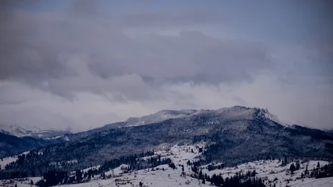 Time lapse of clouds running over white snowy mountain landscape. Winter moun Stock Footage 100742784