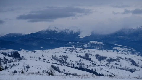 Time lapse of clouds running over white snowy mountain landscape. Winter moun Stock Footage 100742797