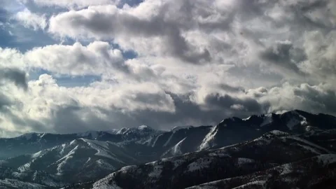 Time-Lapse: Clouds Rush Over Rugged Mountains Stock Footage 92503405